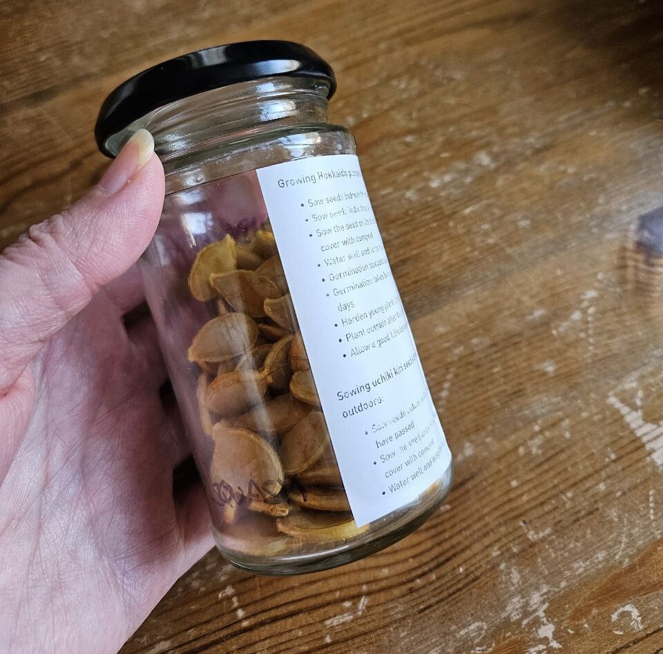 Seeds stored in a glass jar with label